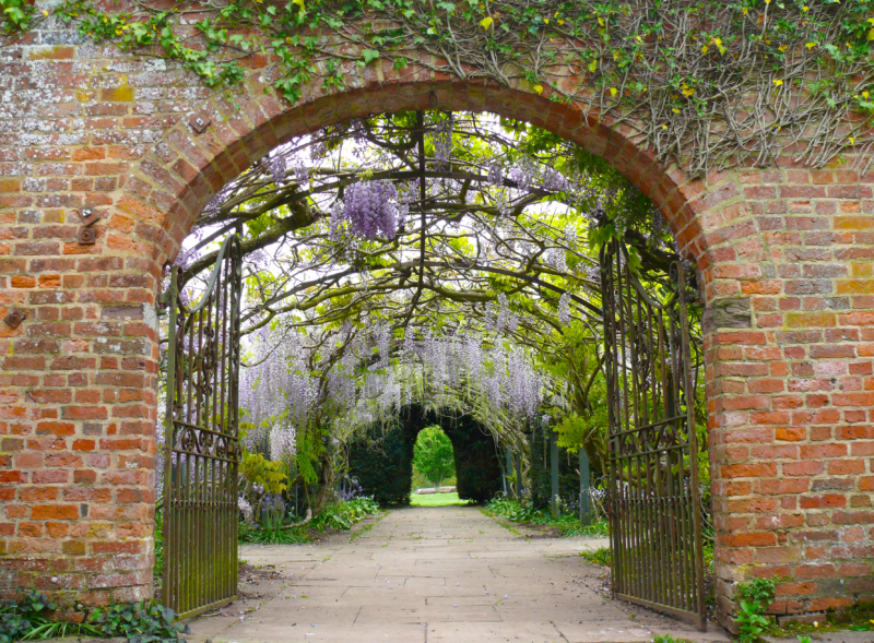Brick archway with gates to wisteria
