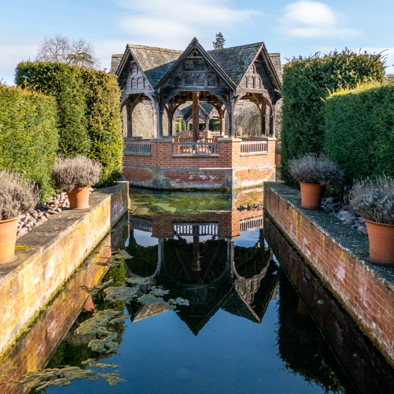 Pavilion with blue sky and reflection in water