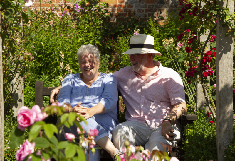 Couple enjoying rose garden