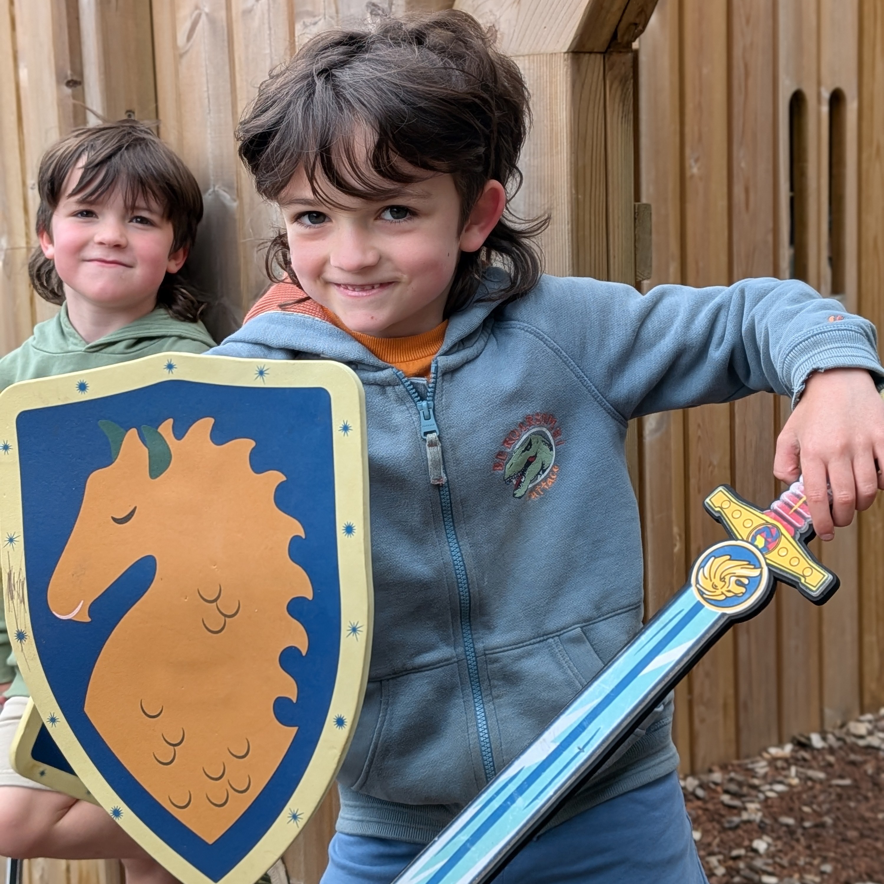 Boy-with-a-shield-and-sword-in-the-play-area-at-Hampton-Gardens 