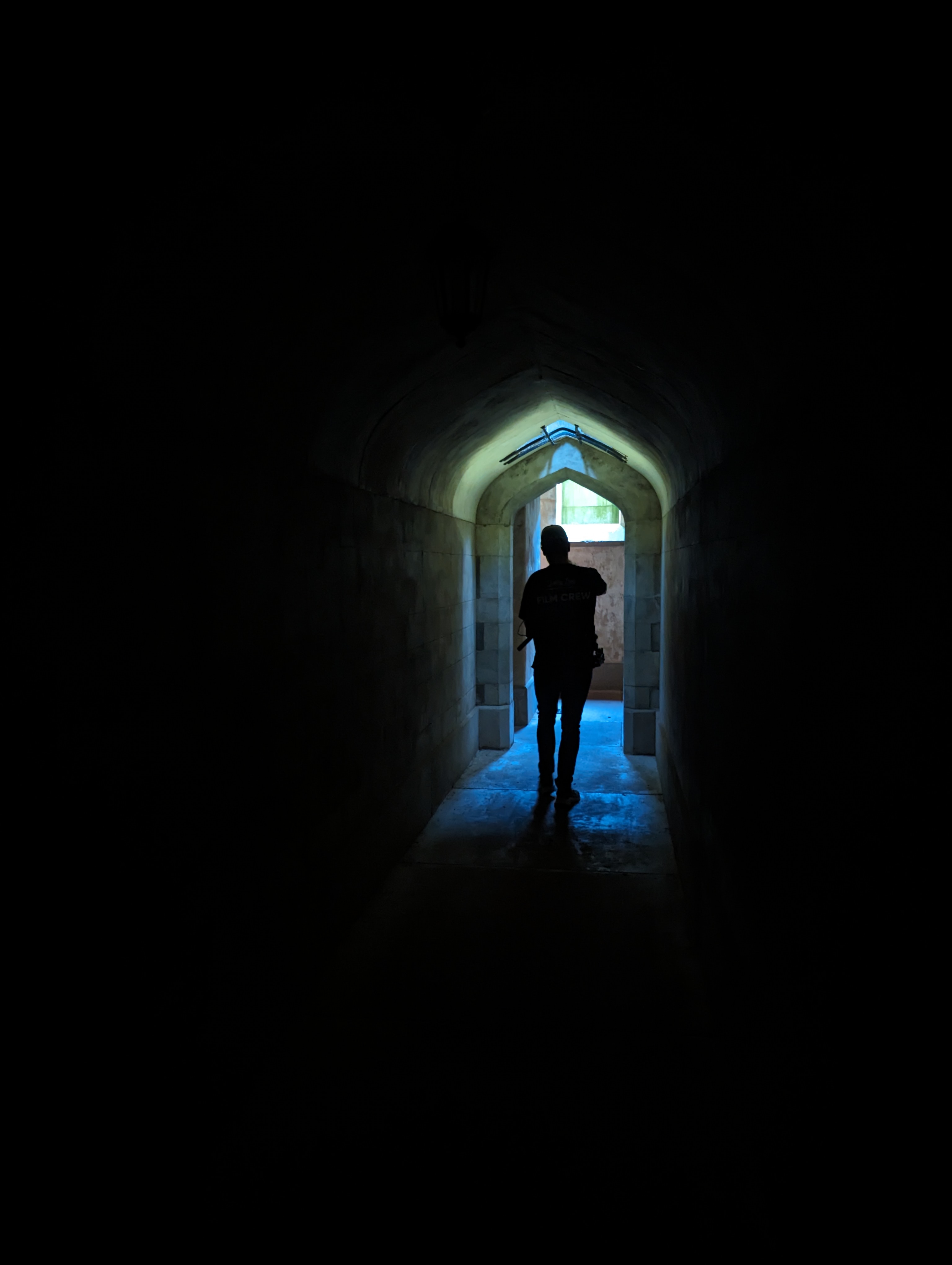 Man-walking-through-dark-tunnel-towards-light