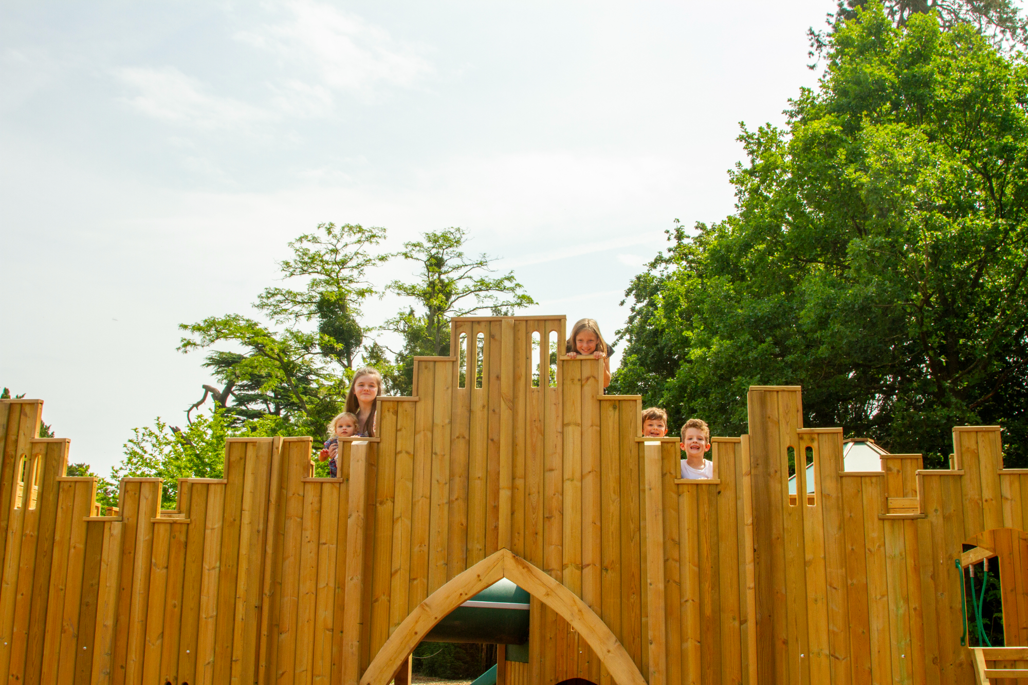 smiling-faces-appear-over-castle-outline-of-childrens-play-area